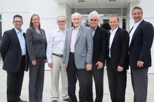 l-r: Al, Harry and Larry Revell pose with representatives from Ford at the official ribbon cutting event at Revell's in Verona on May 28
